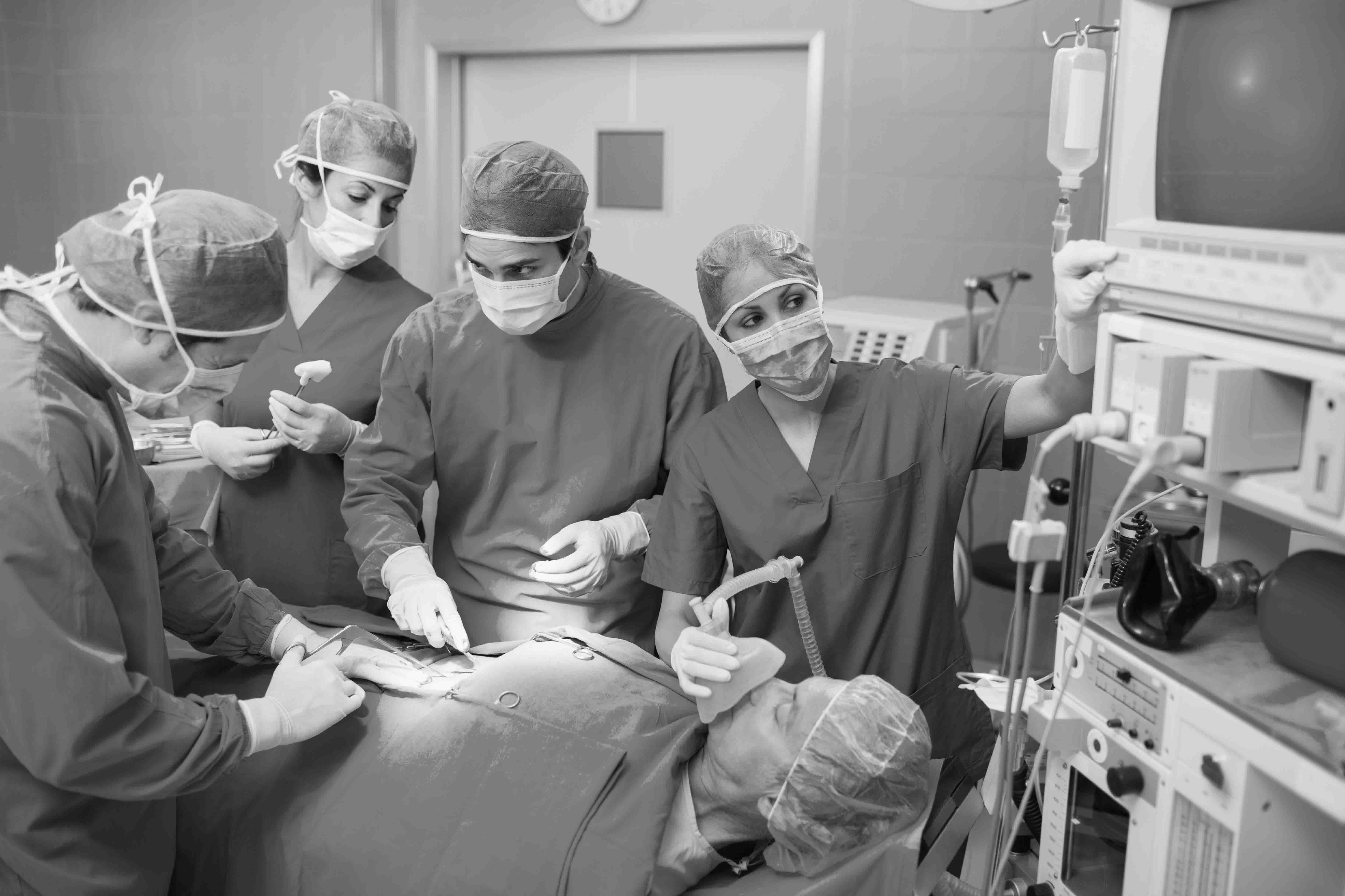 Surgeons operating on a patient in the operation theatre in a coordinated manner to emphasize the importance of teamwork in executing an operation. 